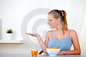 Beautiful blonde young woman eating breakfast