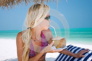 Beautiful blondy holding coconut