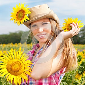 Beautiful Blondy Woman in Cowboy Hat with Sunflowers.