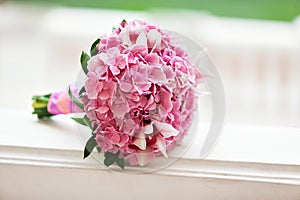Beautiful blossoming pink hydrangea and orchids in weddin bouquet
