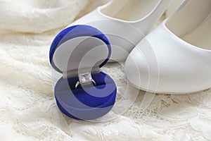 Beautiful blue box with wedding ring.White shoes. wedding shoes. Bride`s high heels. The fees of the bride. Wedding jewelry.