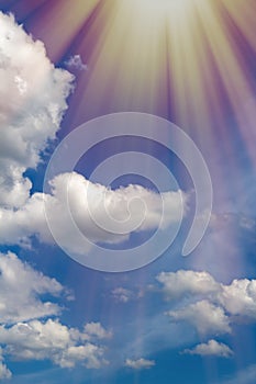 Beautiful blue bright sky, white cumulus clouds and sun rays