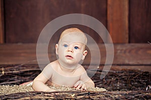 Beautiful blue-eyed baby lying on tummy