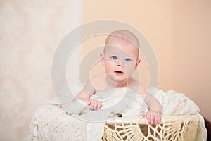 Beautiful blue-eyed baby lying on tummy