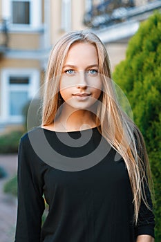 Beautiful blue-eyed girl on the background of houses