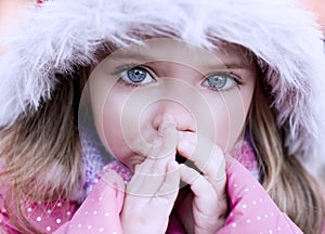 Beautiful blue-eyed girl who warms frozen hands