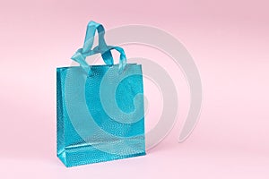 Beautiful blue gift bag on a pink background