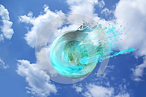 Beautiful blue globe, a model of the planet explodes in spray against the sky with white clouds, the concept of natural nature,