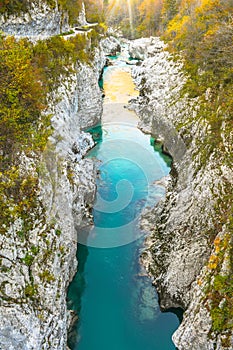 Beautiful blue and green colored, crystal clear Soca river flowing and passing through narrow rock canyon