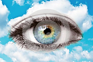 Beautiful blue human eye with bright sky - Spiritual concept