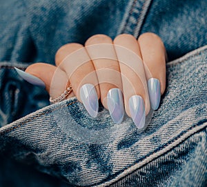 Beautiful blue nail manicure. Stylish pastel blue manicure. Nail polish. Art blue manicure. Female hands manicure close up view on