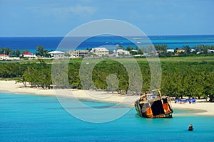 Beautiful blue ocean, an old fishing boat and white sandy beaches of Grand Turk, Turks & Caicos