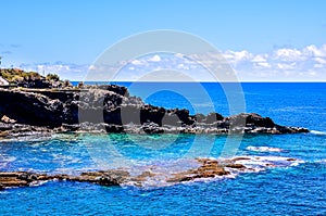 A beautiful blue ocean with a rocky shoreline