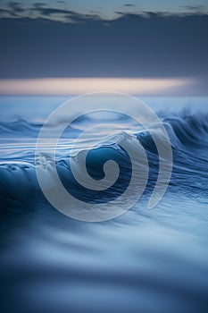 beautiful blue ocean wave close-up at sunset. long exposure