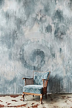 Beautiful blue old vintage chair against the background of a textured wall