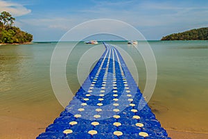 Beautiful blue pontoon made from plastic floating in the sea, rotomolding jetty, a landing stage or small pier at which boats can