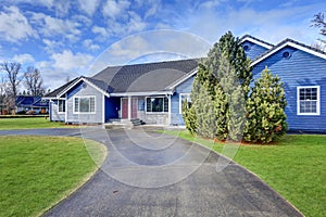 Beautiful blue rambler house with tile roof