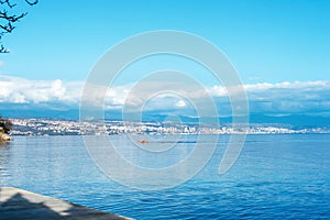 Beautiful blue sea with fishing boat. View of Rijeka city, Croatia