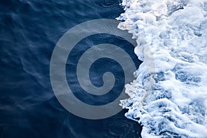 Blue Seawater with sea foam as background