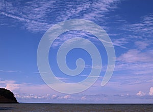 Beautiful blue skies with pattern clouds above the ocean.