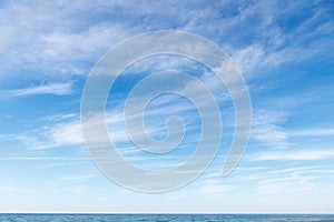 Beautiful blue sky over the sea with translucent, white, Cirrus clouds