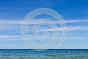 Beautiful blue sky over the sea with translucent, white, Cirrus clouds