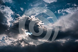 Blue sky with sun and clouds