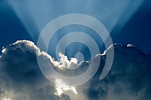 Beautiful blue sky with sunbeams and clouds. Sun rays