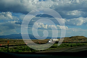 Beautiful blue sky with white clouds in Colorado, USA. A truck