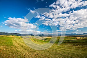 Beautiful blue sky with white clouds over green agricultural fields