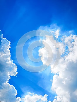 Beautiful blue sky and white clouds with sun rays and space background