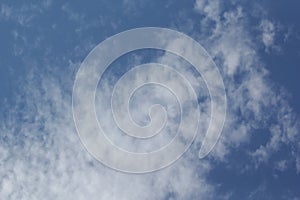 Beautiful blue sky with white fluffy clouds on a clear sunny day