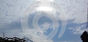 Beautiful blue sky with white gry clouds & trees photo