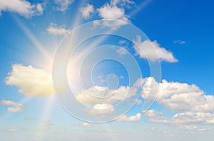 Beautiful, blue summer sky with fluffy clouds and bright sun