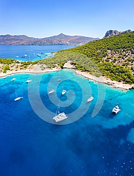 The sea of Moni at Aegina island with sailing boats and people photo