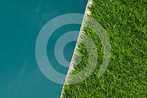 Beautiful Blue Water and Artificial turf green grass. Wallpaper