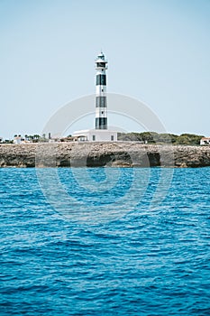 Beautiful blue white lighthouse on the Spanish island of Menorca photo