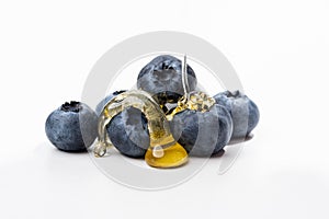 Beautiful blueberries on a white background completely in sharp focus, drenched with honey