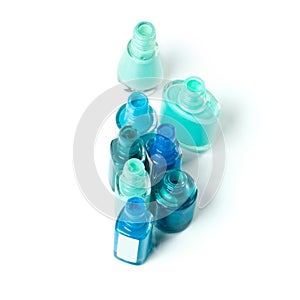 Beautiful blues. An isolated shot of opened bottles of blue nail polish.