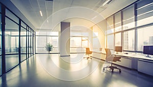 Beautiful blurred background of a light modern office interior with huge panoramic windows and beautiful golden hour lighting