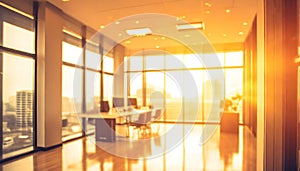 Beautiful blurred background of a light modern office interior with huge panoramic windows and beautiful golden hour lighting