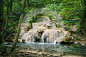 Beautiful blurred motion waterfall in deep green forest