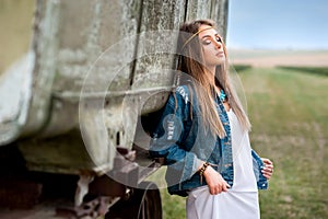 Beautiful boho inspirations girl dream near trailer in field