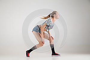 Beautiful booty dancer posing on studio background