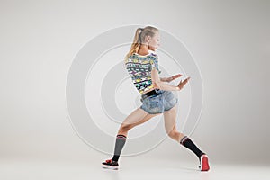 Beautiful booty dancer posing on studio background