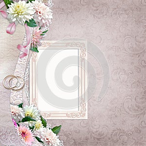 Beautiful border with flowers, frame and wedding rings on a vintage background