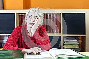 Beautiful bored and tired somnolent student yawning in the morning in a desk at home