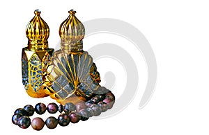 Beautiful bottles of oil perfume in Arabic style and rosaries made of natural stones.