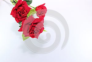 A beautiful bouquet of artificial red roses on white background. Love and romance concept.