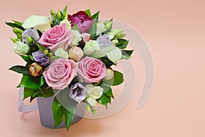 Beautiful bouquet of colorful flowers on a pinkk background close